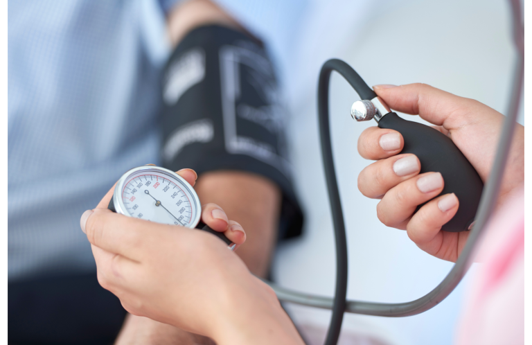A healthcare professional measuring blood pressure with a sphygmomanometer.