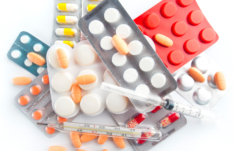Safe Handling of Medicines Assorted medications, including tablets, capsules, and syringes on a white background.