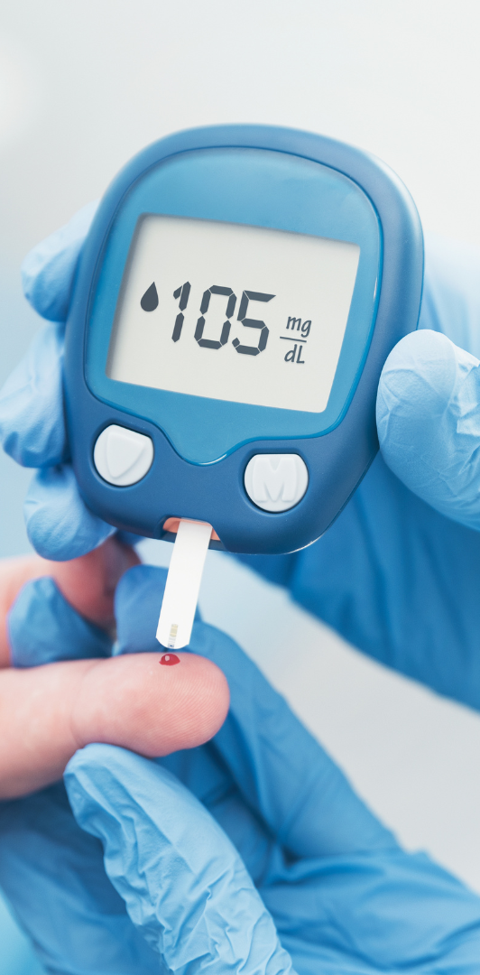 Blood Glucose Monitoring A hand holding a glucose meter reading 105 mg/dL, wearing blue gloves.