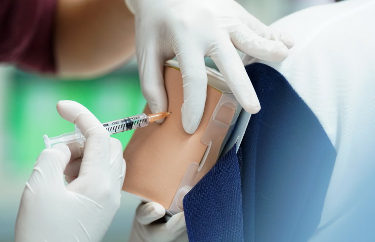 Injection Administration Training Medical professional administering an injection using a training model.