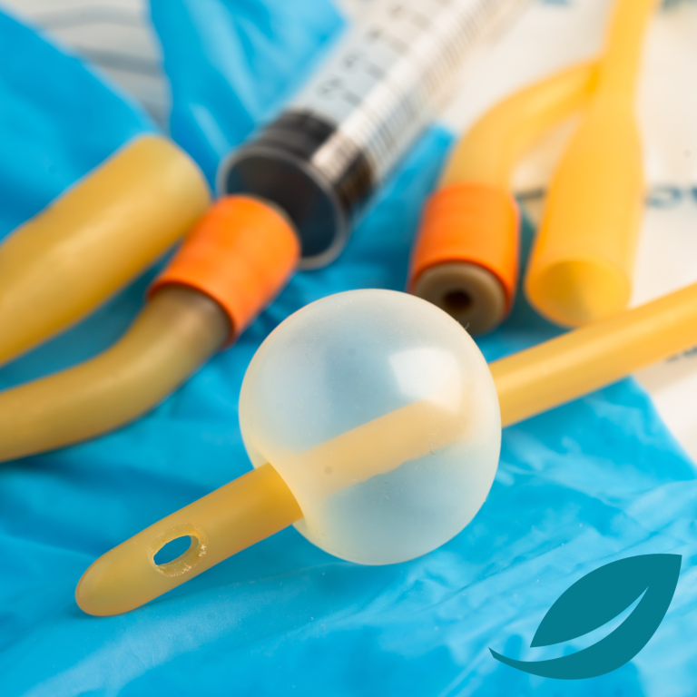 Week 4 - long term conditions Assorted medical tubes and a clear spherical connector on a blue surface.