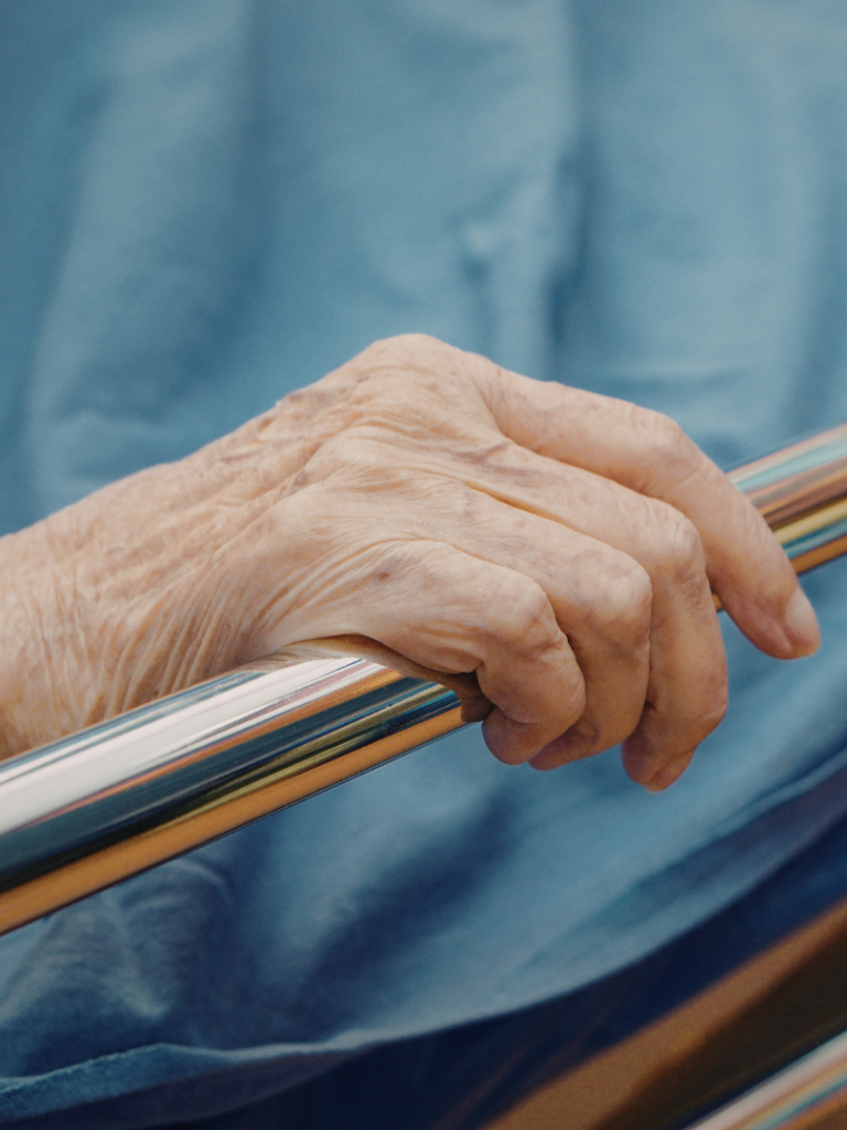 A healthcare professional preparing to extract blood from a patient's arm.