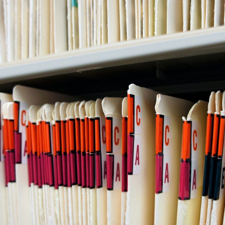 Professional Practice Close-up of neatly organised file folders with colourful labels.