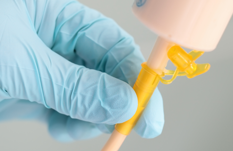 Medical instruments including a stethoscope and pen-like devices on a light background.