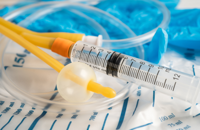 Catheterisation Training for Nurses Medical supplies including syringes, tubing, and gloves on a clinical surface.