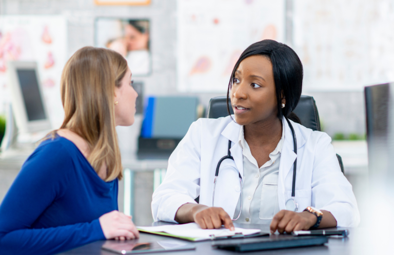 Clinical Supervision for Supervisors A doctor discusses health matters with a patient in a medical office.