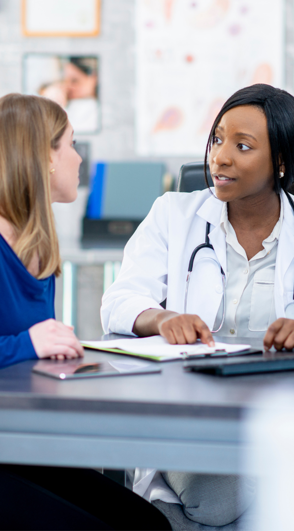 Clinical Risk Assessment and Management A doctor discussing with a patient in a medical office.
