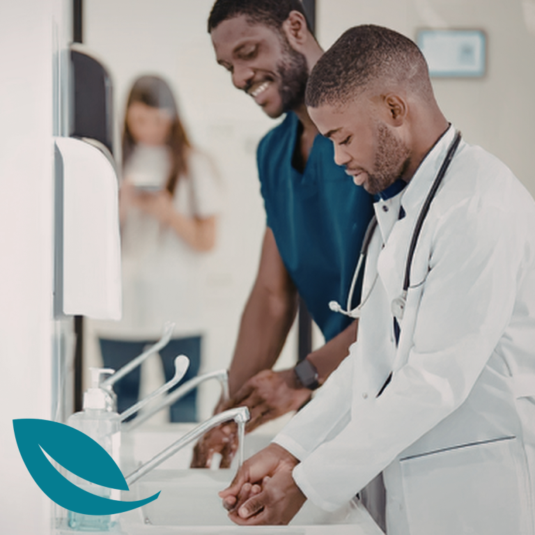 Week 1 - fundamentals Two healthcare professionals washing their hands in a clinical setting.