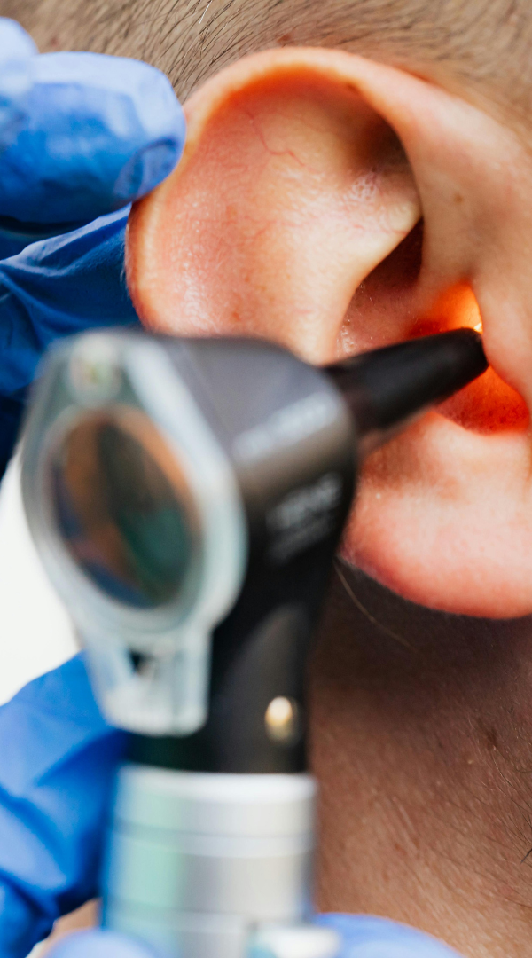 Ear Care Update A healthcare professional using an otoscope to examine a patient's ear.
