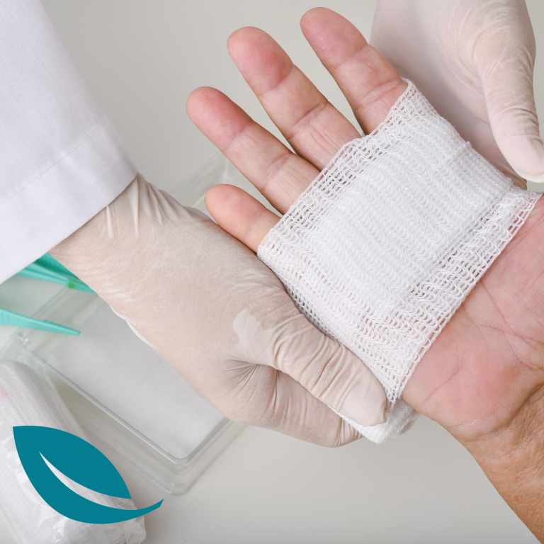 Week 3 - nutrition and wound care A gloved hand applying a bandage to a wounded hand.