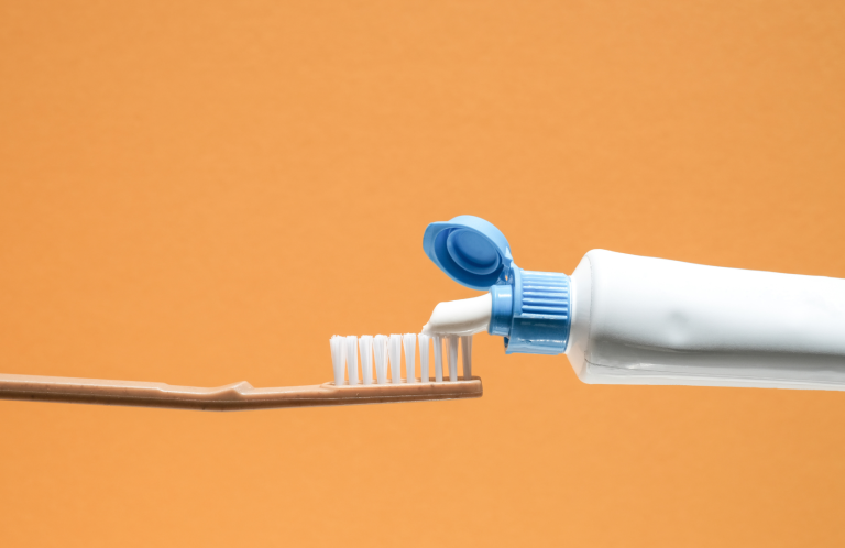 A person receiving foot care, with hands pointing to the ankle area.