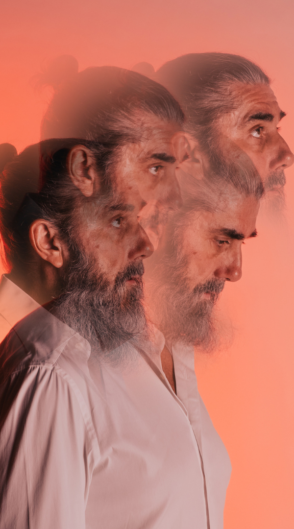 Delirium Management Three overlapping profiles of a man with a beard against a gradient background.
