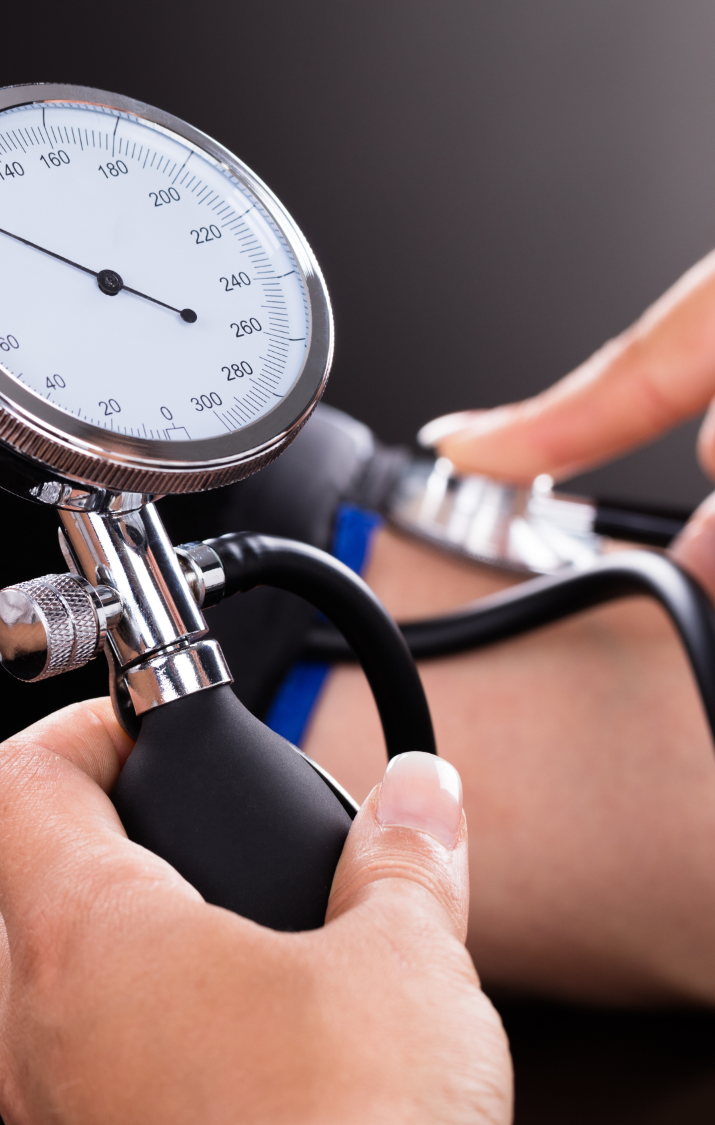 A close-up of a blood pressure monitor being used on a patient's arm.