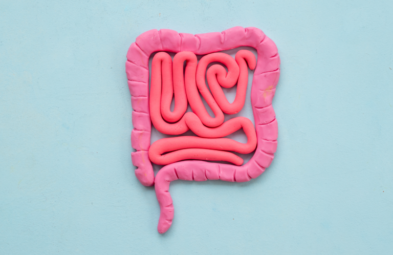 A variety of pills, a syringe, and a blister pack of tablets on a white surface.