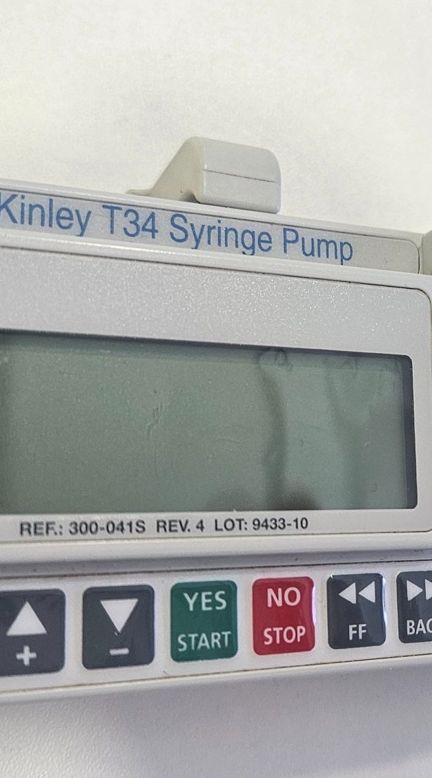 Syringe Driver Management Training Kinley T34 syringe pump with a digital display and control buttons.