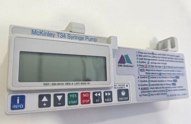 A healthcare professional administering an injection to a training model.