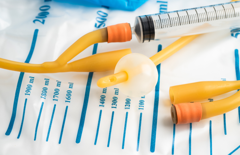 Catheteriation for Registered Practitioners Medical equipment including syringes and tubing on a clinical surface.