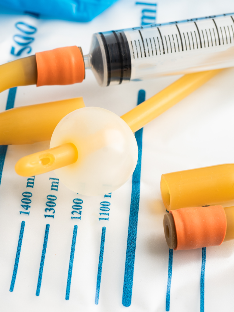 Medical equipment including a syringe and various caps on a sterile surface.