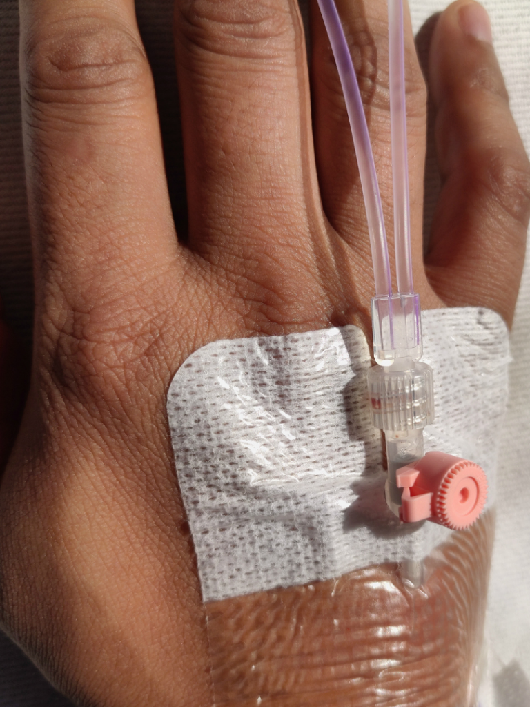 A healthcare professional preparing to extract blood from a patient's arm.