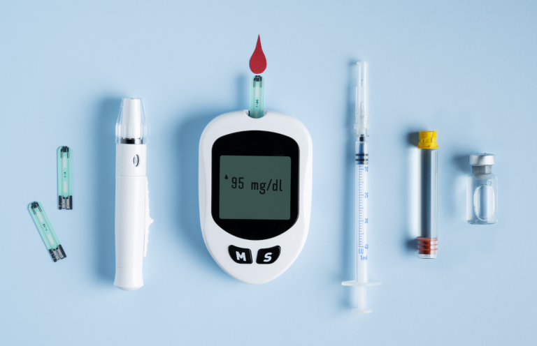 Diabetes and Insulin Administration Diabetes management tools including a glucose meter, test strips, and a syringe.