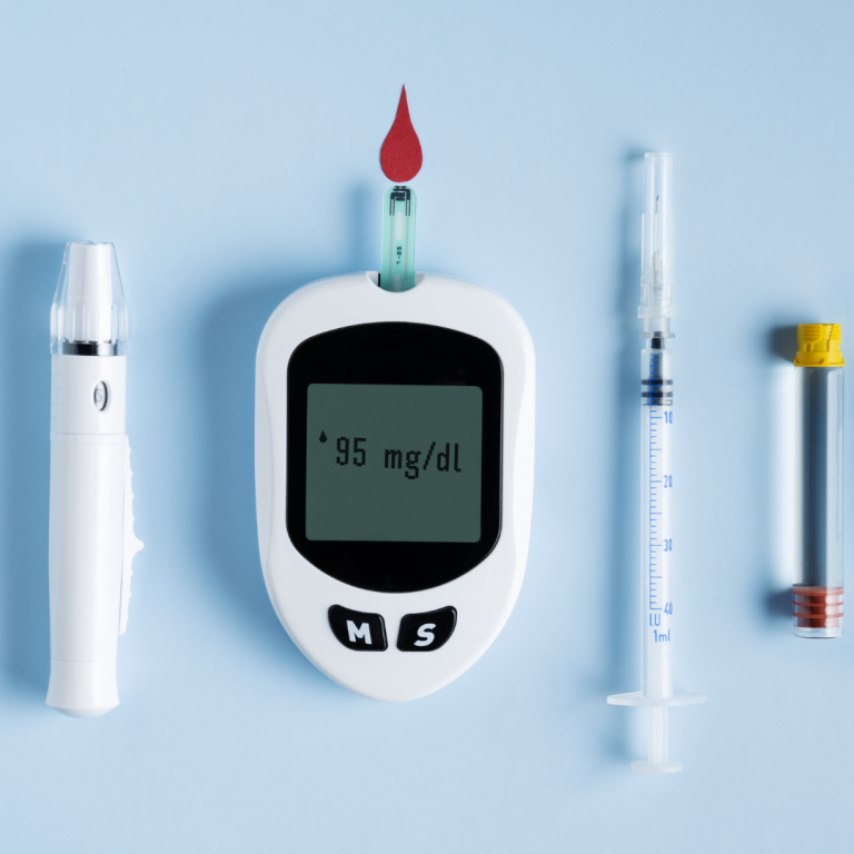 Long Term conditions Blood glucose meter with a drop of blood, syringe, and test vials on a blue background.