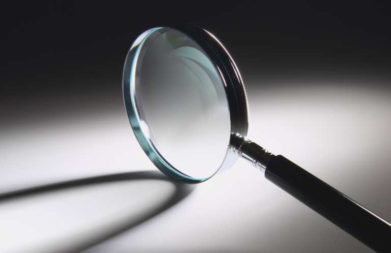 Verification of Death Magnifying glass resting on a surface, casting a shadow.