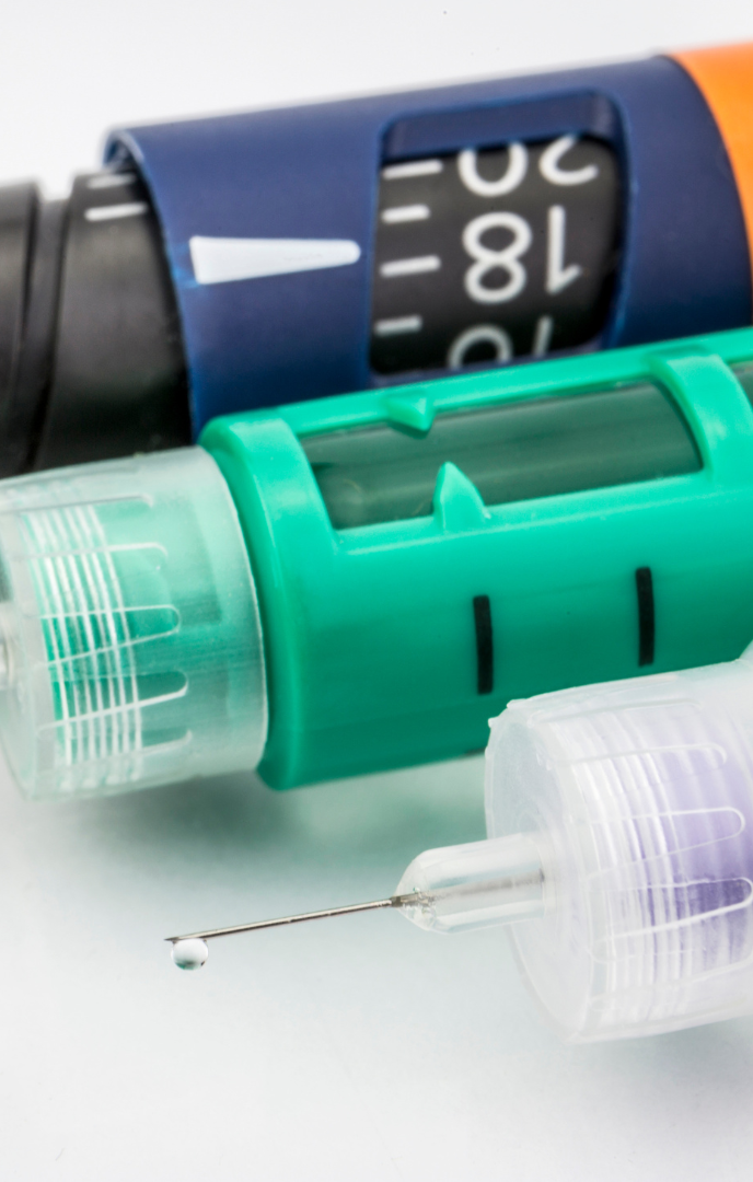 Close-up of various insulin pen devices and syringes.